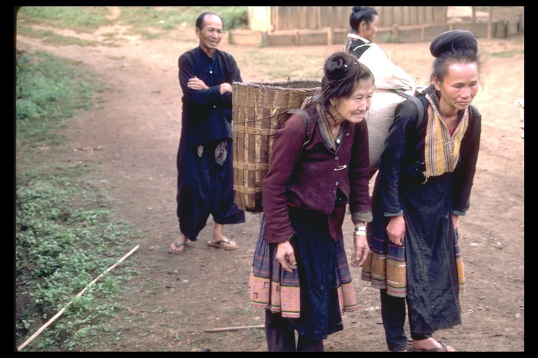 Hmong women with back baskets, Bua Chan, Thailand, 1986